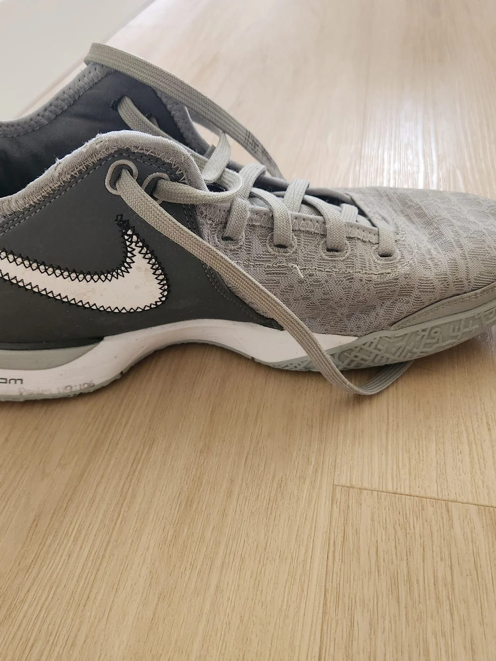 Nike Gray and White Low-Top Sneakers with Gold Swoosh